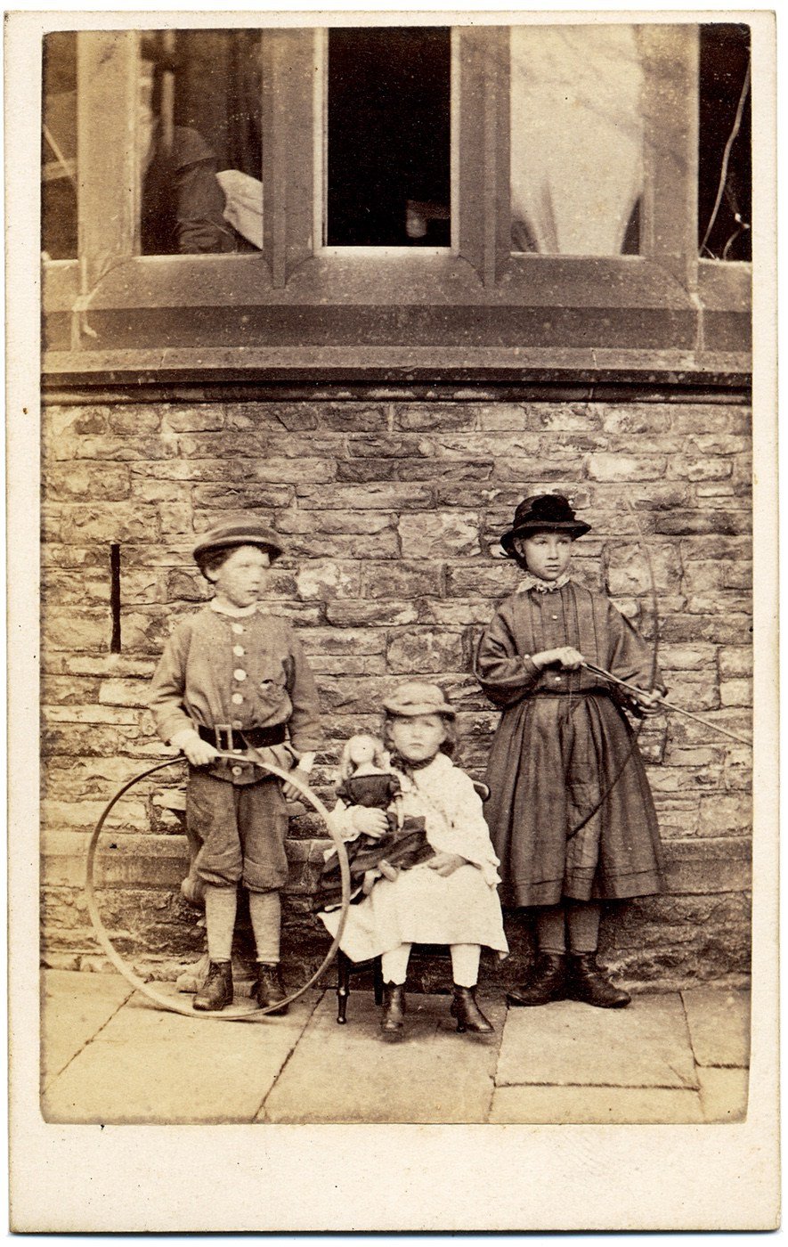 Coll. Ronald Sewell, (from Dorothea Little) 
Verso: blank but associated with von Dix cartes de visite. Date ca 1865
An adult woman looks down onto an archer, hoop boy and younger girl with a dolly.  Von Dix also worked in Consett, ran magic shows in Alston Town Hall, ran the Weary Sportsman pub- now called Low Bayles on the Hartside road, worked with his female partner, Smedl(e)y
Presumed to be Octavius & Jane Catherine James' family. Most likely: L>R Hugh Salvin James, 1857-1934, Mildred Althea James, 1859-1937 and Elizabeth May James,  1854-1937.  Clarghyll Hall- defining characteristic: the undercroft ventilating slit to the left of the belted boy, Hugh + the curved window.