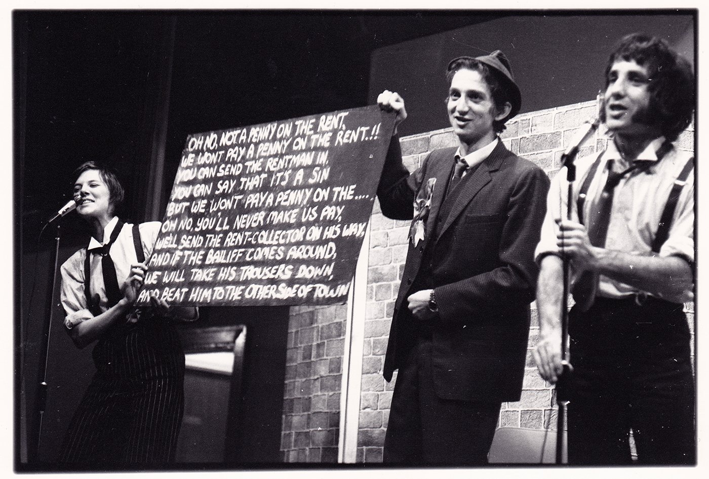 7:84  a radical leftist theatre group, (name derived from the fact that 7% of the world own 84% of its wealth), wrote this play/theatrical experience based on the 'demolition' of the CDP & its projects by the combined forces of the Conservative Party-dominated Cumbria County Council hand in hand with the Freemasons in the town. It was performed in the Civic Centre. To the right is the late Brian Hibbard, later to be front singer in The Flying Pickets and to star in the soap opera Coronation Street.